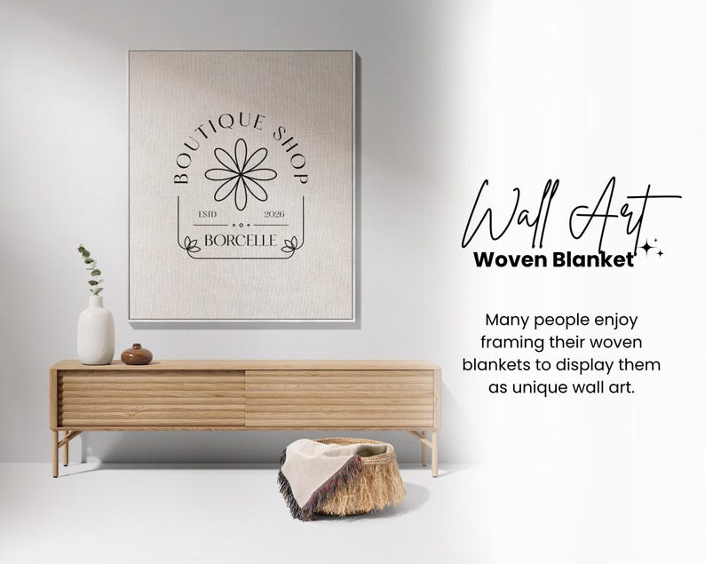 May include: A framed wall art piece with a floral logo and the text "BOUTIQUE SHOP". A wooden console table holds a vase, decorative items, and a woven basket with a blanket. The text "Wall Art Woven Blanket" is also visible.