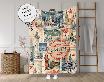 May include: A personalized blanket featuring a collage of vintage postage stamp designs with winter scenes, including churches, trees, and Santa Claus. The blanket has a cream background with red and blue accents, and includes the family name "SMITH".