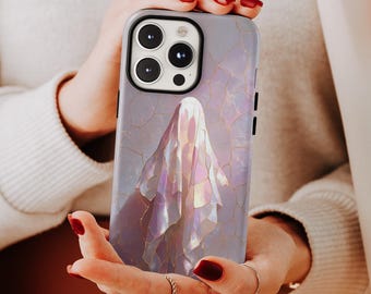 May include: A phone case with a pearlescent, iridescent design featuring a ghost figure. The case has a light purple background with gold-colored crackle lines. The phone case has a black camera module and black side buttons.
