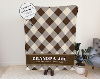 May include: A brown, cream, and white plaid blanket with the text "GRANDPA JOE" and the names of the grandkids. The blanket has a custom design and is available in three sizes.