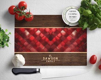 May include: A wooden cutting board with a red quilted design and gold trim. The text "The Dawson Family" is printed on the board. The words "Glass Cutting Board + Hygienic & resistant" are also visible.
