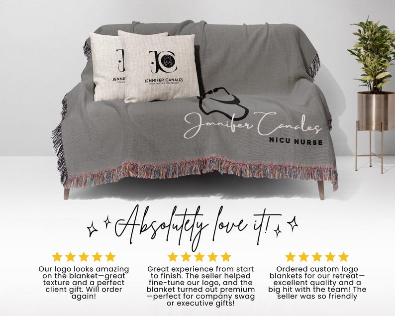 May include: A gray woven throw blanket with fringe, draped over a sofa, featuring two throw pillows. The blanket has the text "Jennifer Candes NICU Nurse" and a logo. The pillows have the text "Jenni" and "Jennifer Canales".