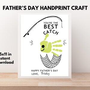 May include: A framed Father's Day handprint craft. The artwork features a green handprint with a smiling face, a fishing rod, and the text "YOU'RE THE BEST CATCH." The words "HAPPY FATHER'S DAY" and "LOVE, Brady" are also included. The print measures 8.5x11 inches.