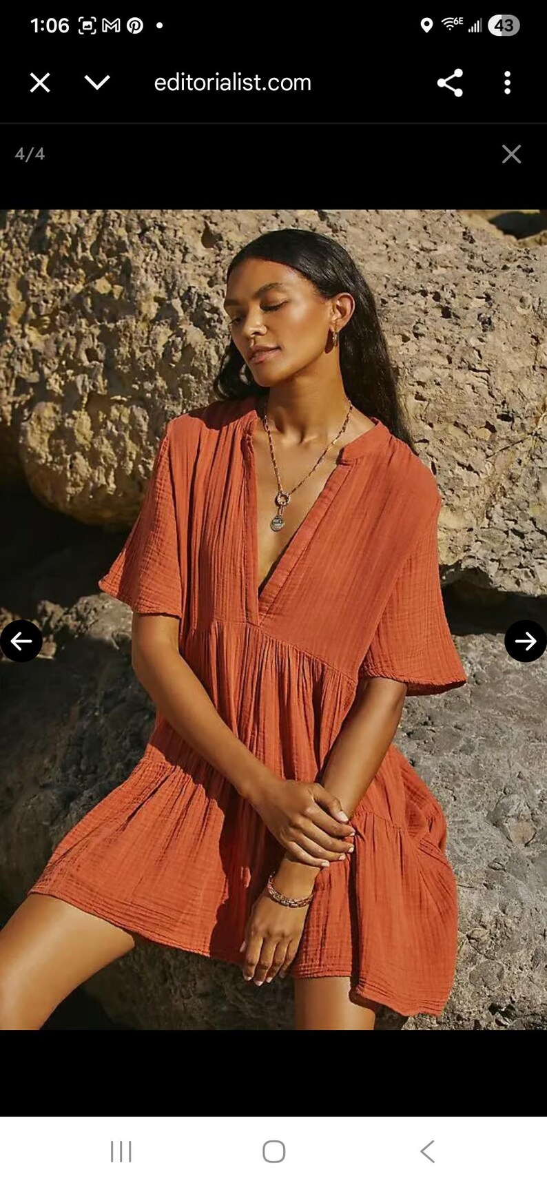 May include: Rust-colored mini dress with short sleeves and a V-neckline. The dress has a tiered skirt and is made of a textured fabric. The model is wearing a necklace and bracelet. The website editorialist.com is visible in the image.