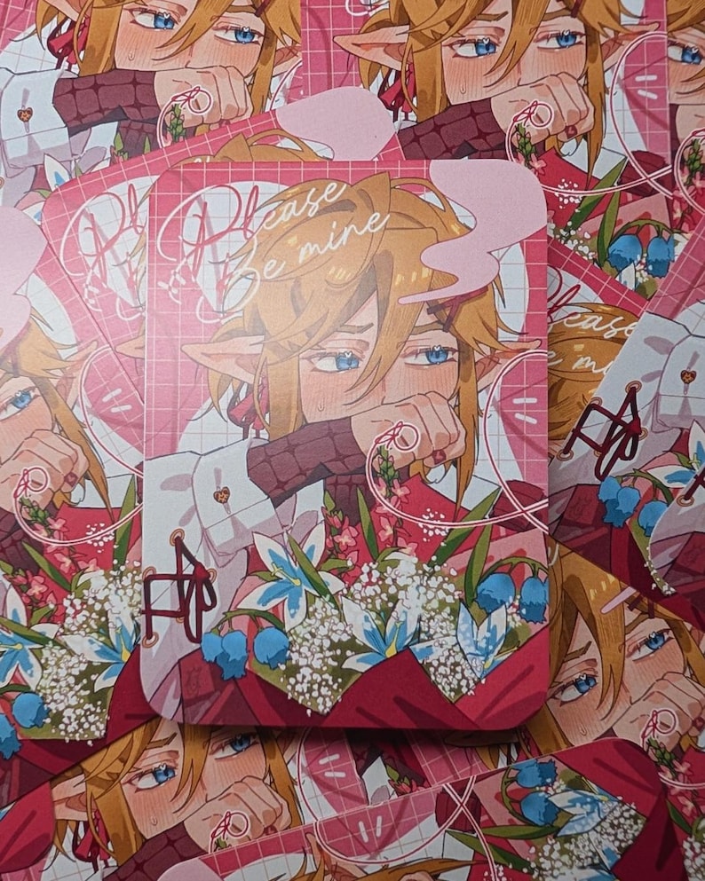 May include: A stack of pink and red art prints featuring an anime-style character with blonde hair and blue eyes. The prints have the text "Please Be Mine" and a floral bouquet design.