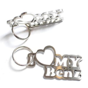 May include: Silver keychain with a heart and the words "I love my Benz".