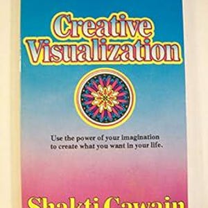 May include: A paperback book titled Creative Visualization by Shakti Gawain with a blue to pink gradient cover. The title is in yellow with a white outline. A circular mandala graphic with pink, blue, and yellow patterns sits in the centre.