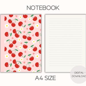 May include: A notebook with a pink cover featuring a pattern of red cherries, white flowers, and small pink hearts. The notebook is labeled "NOTEBOOK" and "A4 SIZE". The right page is lined.