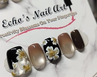 Vintage zwarte kunstnagels met bloemenprint en bruine cat eye-look: Luxe feestnagels voor de herfst