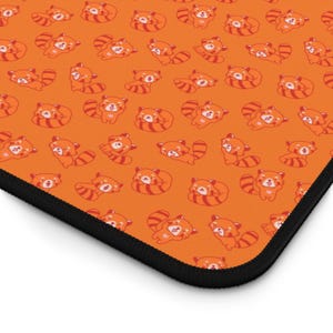 May include: Orange background with a repeating pattern of red pandas. The red pandas are all facing the same direction and have a happy expression on their faces.