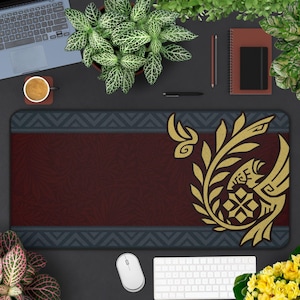 May include: A dark red and blue mousepad with a gold design of a stylized bird with a floral pattern. The design is in the upper right corner of the mousepad.