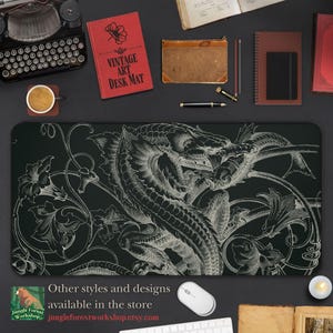 May include: A black and white mouse mat featuring a detailed illustration of a dragon and floral designs. The text "Other styles and designs available in the store jungleforestworkshop.etsy.com" is at the bottom of the mouse mat.