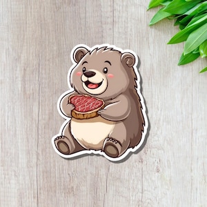 Pegatina de vinilo de un oso comiendo un filete