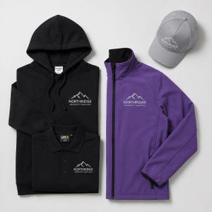 May include: A black hooded sweatshirt, a black polo shirt, a purple zip-up jacket, and a gray baseball cap. Each item features an embroidered white logo of a mountain range above the text Northridge Property Services in a clean font.