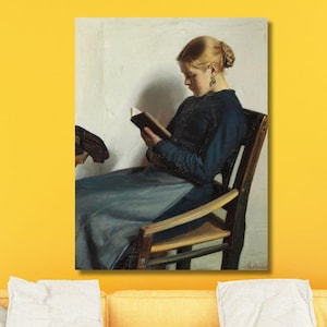 May include: A painting of a woman sitting in a chair and reading a book. She is wearing a blue dress and has blonde hair. The painting is set against a white background.