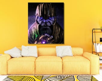 May include: A rectangular wall art print featuring a portrait of a purple-skinned character wearing a gold helmet and armor. The character has glowing blue eyes and a metallic gauntlet with a glowing purple stone on one hand, set against a dark background.