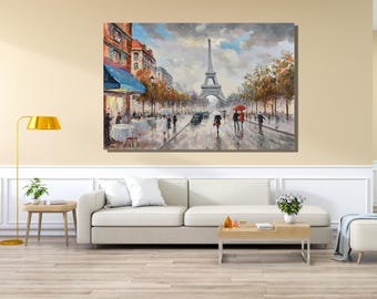 May include: A rectangular canvas wall art print depicting a rainy Parisian street scene with the Eiffel Tower in the distance. The painting features figures walking with umbrellas, a sidewalk cafe with blue awnings, and autumn-toned trees.