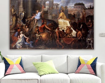May include: A rectangular wall art print featuring a classical oil painting of a historical procession with figures in ancient attire, an elephant, horses, and ornate architecture under a cloudy sky, displayed above a white sofa with colorful pillows.