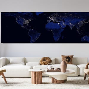 May include: A panoramic rectangular wall art print featuring a dark blue world map at night. The continents are depicted in deep navy tones, while the populated areas are illuminated by bright white and yellow city lights across the globe.