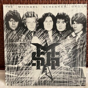 May include: Album cover for The Michael Schenker Group. The cover features five men in a black and white design. The band's name is at the top, and the initials "MSG" are in the centre, with a star and guitar graphic.