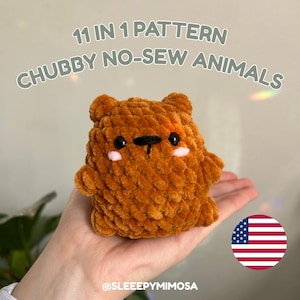 May include: A handmade, no-sew, plush bear in a warm brown color. The bear has black eyes, a black nose, and pink cheeks. The text "11 IN 1 PATTERN CHUBBY NO-SEW ANIMALS" is displayed above the bear. The Etsy shop name is @SLEEEPYMIMOSA.
