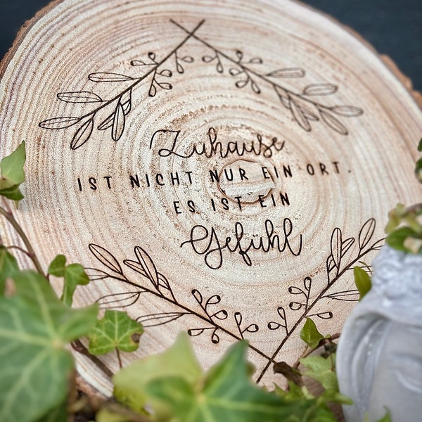 Engraved tree disc made of untreated wood - ‘Home is not just a place’, rustic wall decoration, 25-30 cm