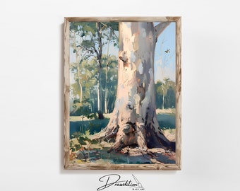 May include: A framed landscape painting depicts a large tree with a light-colored trunk, set against a backdrop of a forest and a blue sky. The artwork is rendered in soft, blended brushstrokes, with a focus on natural light and shadow.