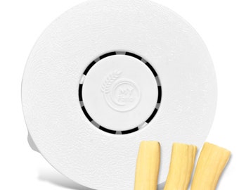 May include: A white pasta maker with the text "MY Pasta" and three pieces of uncooked pasta. The pasta maker has a textured surface and a circular design. The pasta pieces are light yellow.