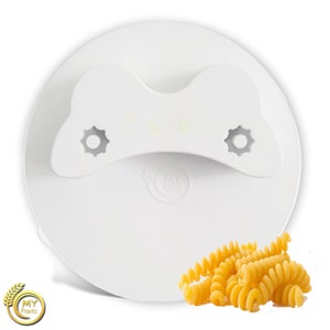 May include: White plastic lid with a bone-shaped handle and two small holes on either side. The lid is designed for a pasta container. A pile of cooked pasta is in the foreground.