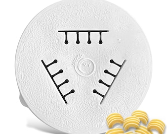 May include: White plastic pasta maker attachment with a design of three rows of holes. The attachment is designed to make a type of pasta that looks like small, curved shells. There are several of these pasta shells in the lower right corner of the image.