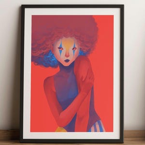 Peut inclure: Une impression d'art encadrée représentant un portrait stylisé d'une personne avec un maquillage de clown. La personne a des cheveux roux, des accents bleus et est placée sur un fond rouge. L'œuvre est encadrée dans un cadre noir.