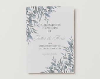 May include: A wedding invitation with a watercolor design of blue leaves and branches. The text reads: "You are invited to the wedding of Justin & Annie, 2 PM, Saturday July 15th 2024, 123 Main St, State Rd, MI, reception to follow."