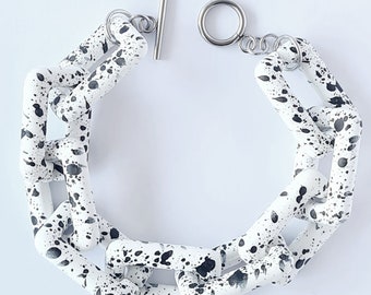 A handmade chunky acrylic/plastic white black dotty/pattern rectangle link bracelet with toggle stainless steel clasp