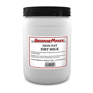 May include: A white plastic container of non-fat dry milk powder from Sausage Maker. The label is red and white with the text "Sausage Maker", "Non-Fat Dry Milk", and directions for use. The container is 1 lb (454 g).