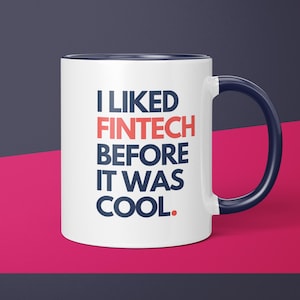 May include: White ceramic mug with a blue rim and handle. The mug has the text "I LIKED FINTECH BEFORE IT WAS COOL." printed in blue and red.