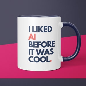 May include: White ceramic mug with a blue rim and handle. The mug has the text "I LIKED AI BEFORE IT WAS COOL." printed in blue and red.