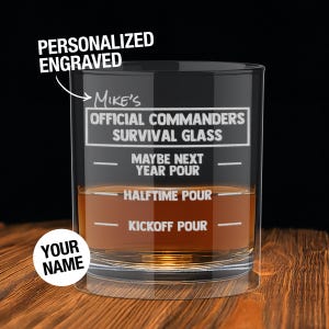 May include: A personalized engraved glass with the text "Mike's Official Commanders Survival Glass." The glass has fill lines labeled "Maybe Next Year Pour," "Halftime Pour," and "Kickoff Pour." The words "Your Name" are also visible.