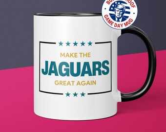 May include: White ceramic coffee mug with a black handle and black rim. The mug has a graphic of a political campaign slogan with the text "Make the Jaguars Great Again" in gold and teal lettering.
