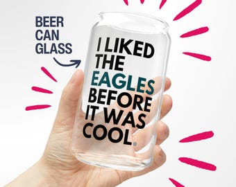 May include: A clear glass beer can with the text "I LIKED THE EAGLES BEFORE IT WAS COOL." printed on it.