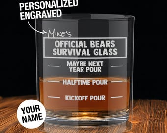 May include: A personalized engraved glass with the text "Mike's Official Bears Survival Glass." The glass has markings for "Kickoff Pour," "Halftime Pour," and "Maybe Next Year Pour." The words "Your Name" are also visible.