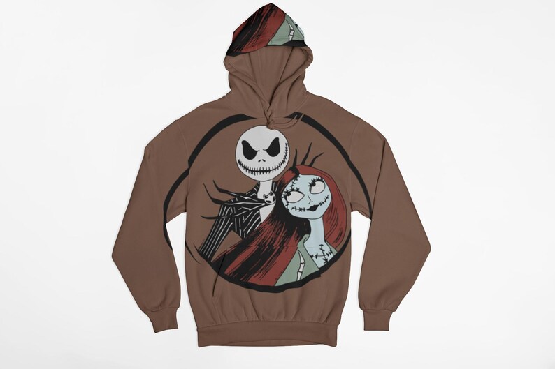 May include: A brown hooded sweatshirt with a graphic print of Jack Skellington and Sally from the Nightmare Before Christmas movie. The print is in a circle with a black outline.