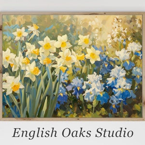 May include: A framed floral print featuring a vibrant garden scene. The artwork showcases white and yellow daffodils, blue irises, and other flowers. The painting has a light wooden frame and the text "English Oaks Studio" at the bottom.