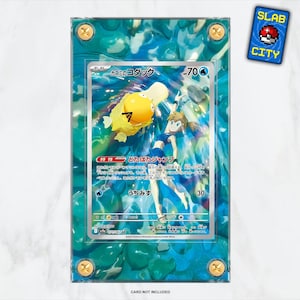 Vitrina de cartas Pokémon con ilustraciones extendidas de Rivales Destinados de Psyduck de Misty