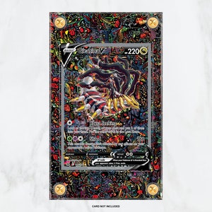 May include: A black and silver Pokemon card featuring Giratina V, a dark and powerful Pokemon with a menacing expression. The card is encased in a protective acrylic case with a colorful, abstract design.