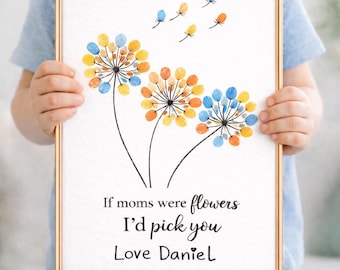May include: A framed print with dandelion-style flowers made from colourful fingerprints. The artwork includes the text "If moms were flowers I'd pick you Love Daniel". The frame is gold.