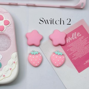 Pink star and strawberry silicone thumb grips designed for Nintendo Switch 2 Joy-Con controllers.