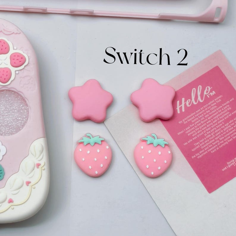 Pink star and strawberry silicone thumb grips designed for Nintendo Switch 2 Joy-Con controllers.