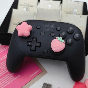Cute pastel strawberry and star joystick covers compatible with Nintendo Switch 2 only.
