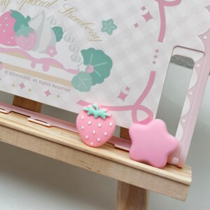 Set of four kawaii Joy-Con grips for Nintendo Switch 2 featuring pink star and strawberry design.