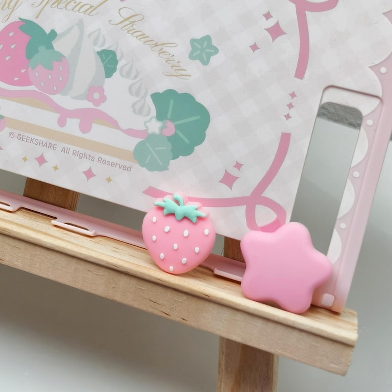 Set of four kawaii Joy-Con grips for Nintendo Switch 2 featuring pink star and strawberry design.